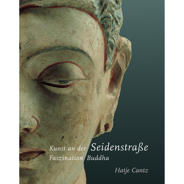 Nahaufnahme des verwitterten Gesichts einer antiken Buddha-Statue auf dem Buchcover von Kunst an der Seidenstraße, Faszination Buddha.
